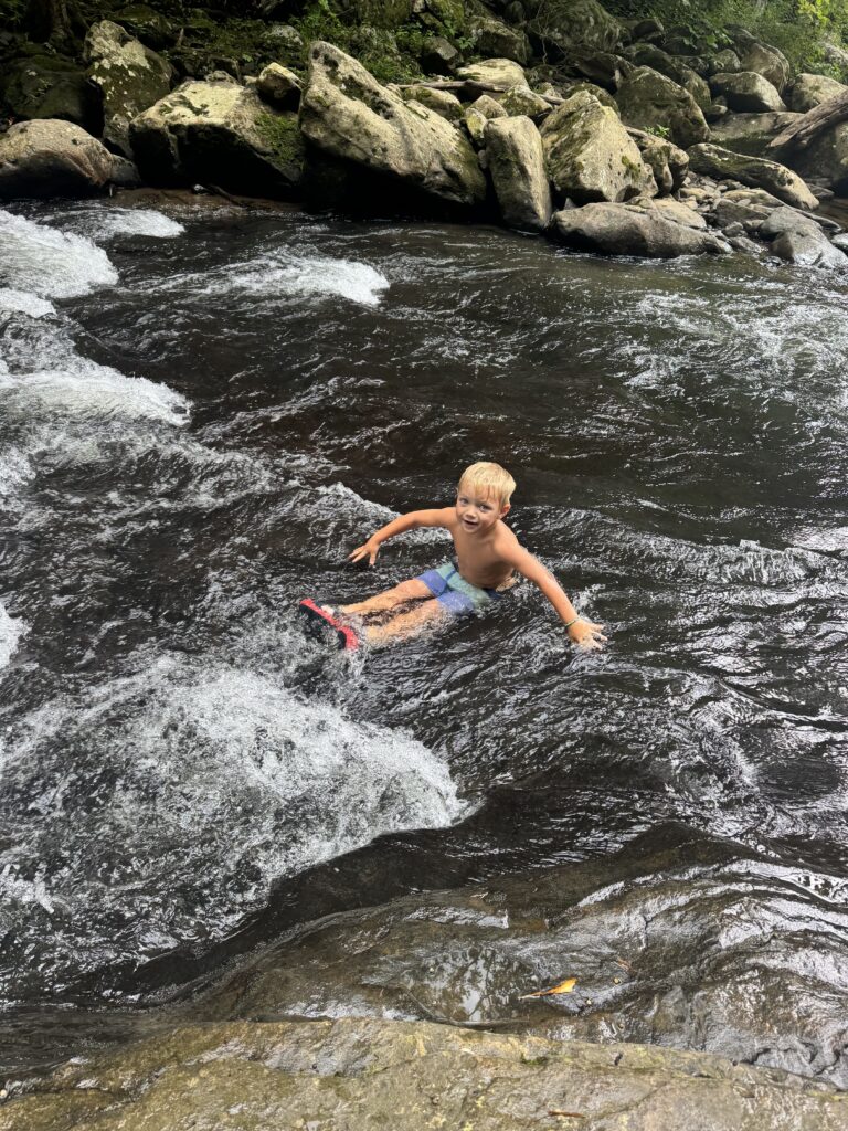 boy at meadow run natural waterslides
