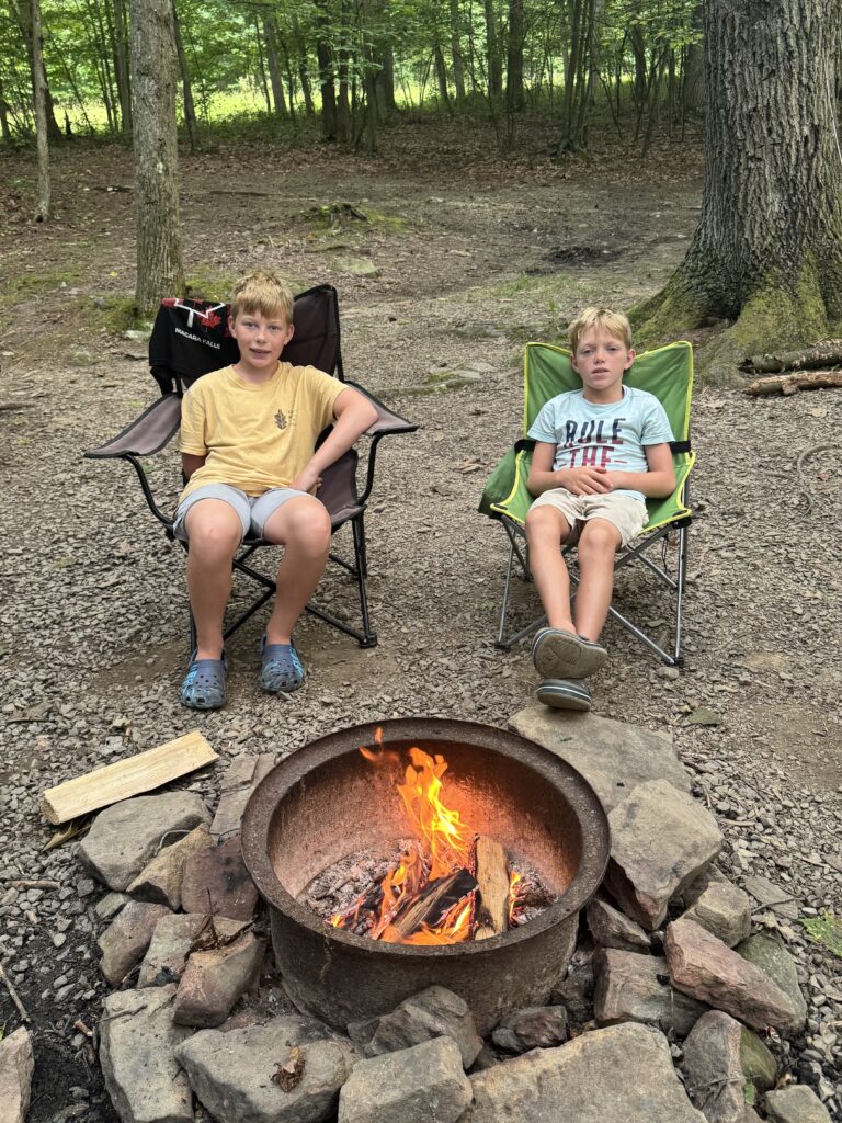 kids sitting at campfire at benners meadow campground