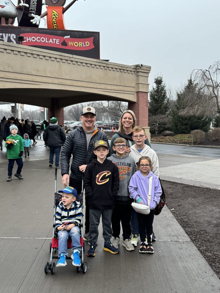 family standing in front of hersheys chocolate world