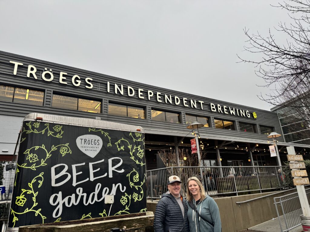 man and woman in front of troegs independent brewing