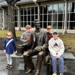 kids next to statue of abraham lincoln in front of gettysburg museum