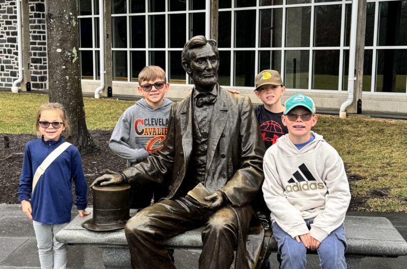 kids next to statue of abraham lincoln in front of gettysburg museum