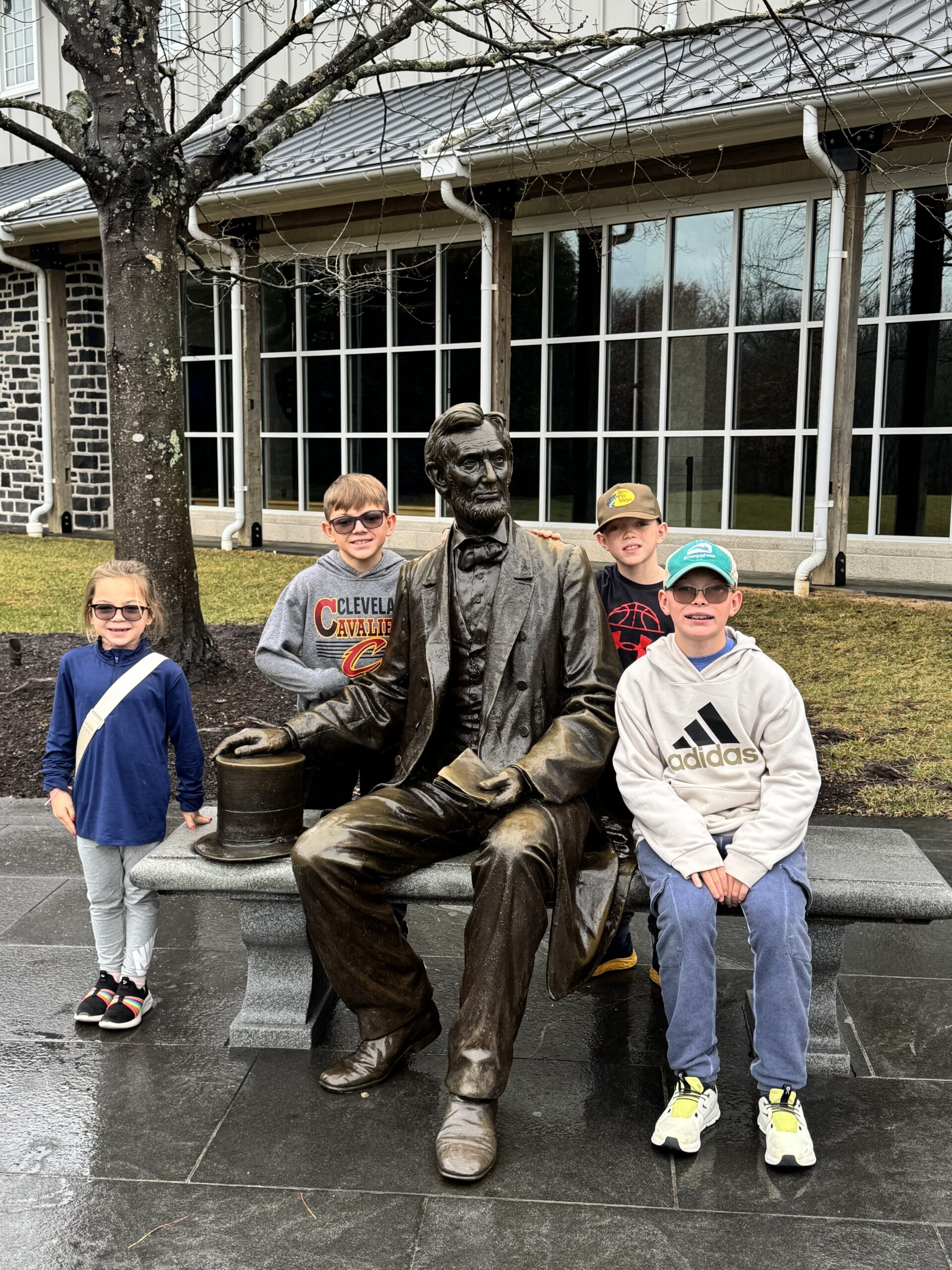 kids next to statue of abraham lincoln in front of gettysburg museum