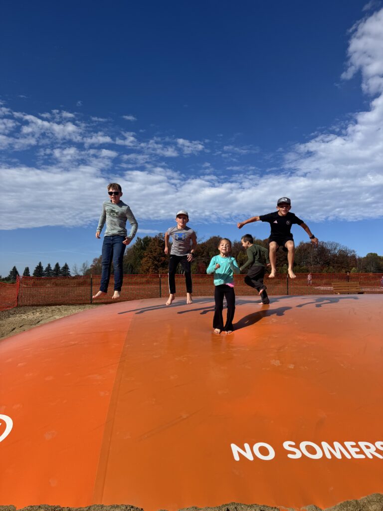 four kids on jumping pillow at hornyak farms