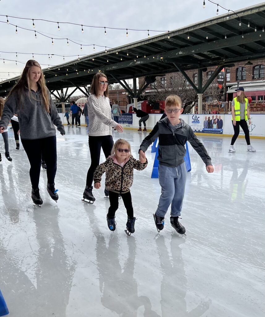 Families ice skating at Ice on the Landing in downtown Chattanooga.