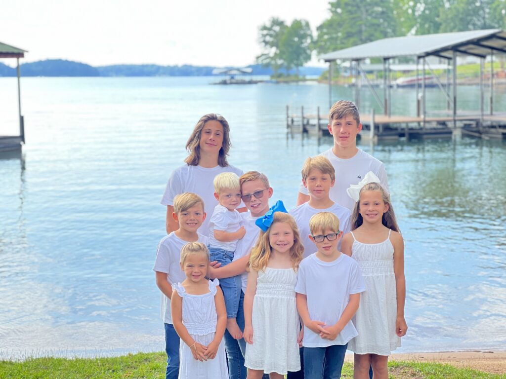 kids posing for picture with lake keowee in background