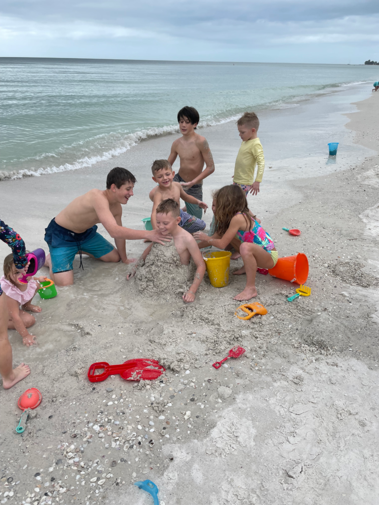 Kids playing in sand on Anna Maria Island family beach vacation
