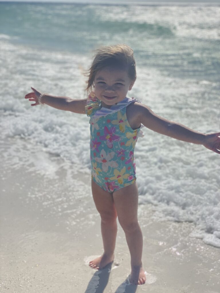 Kids playing in shallow water on Anna Maria Island family beach