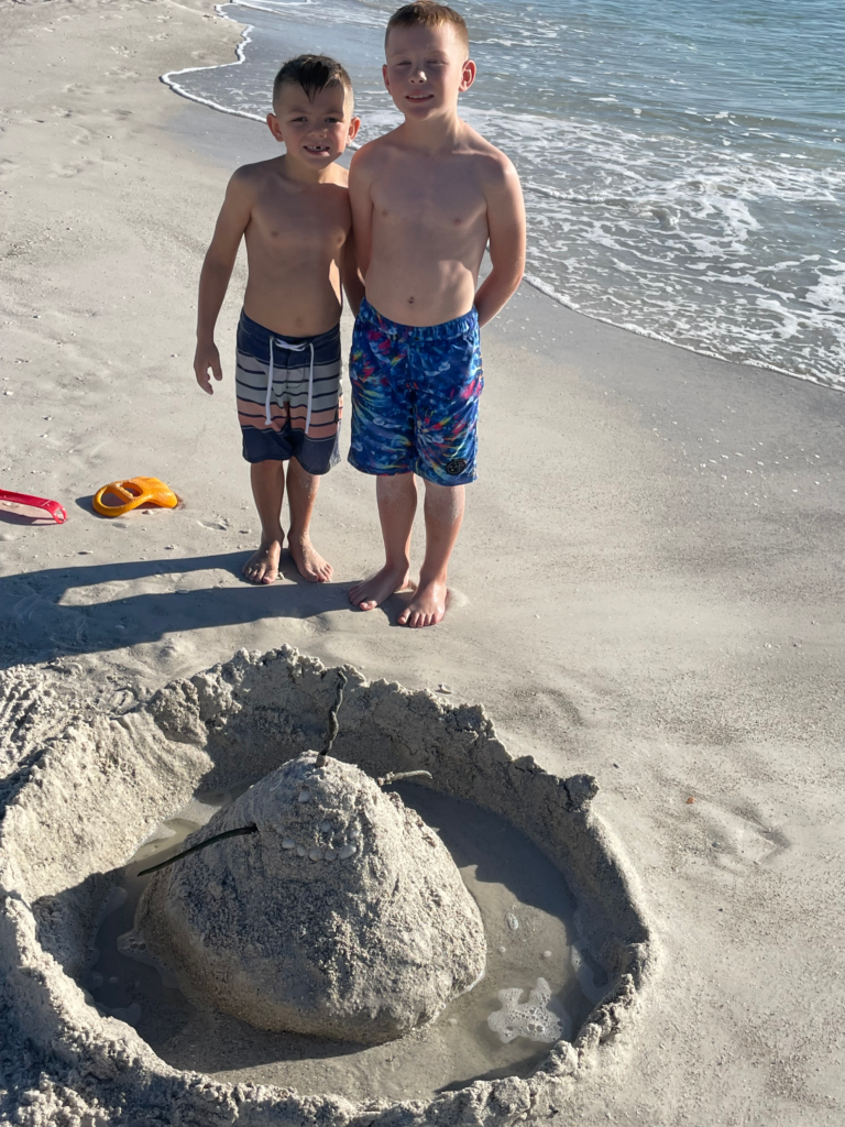 Kids playing in sand on Anna Maria Island family beach vacation