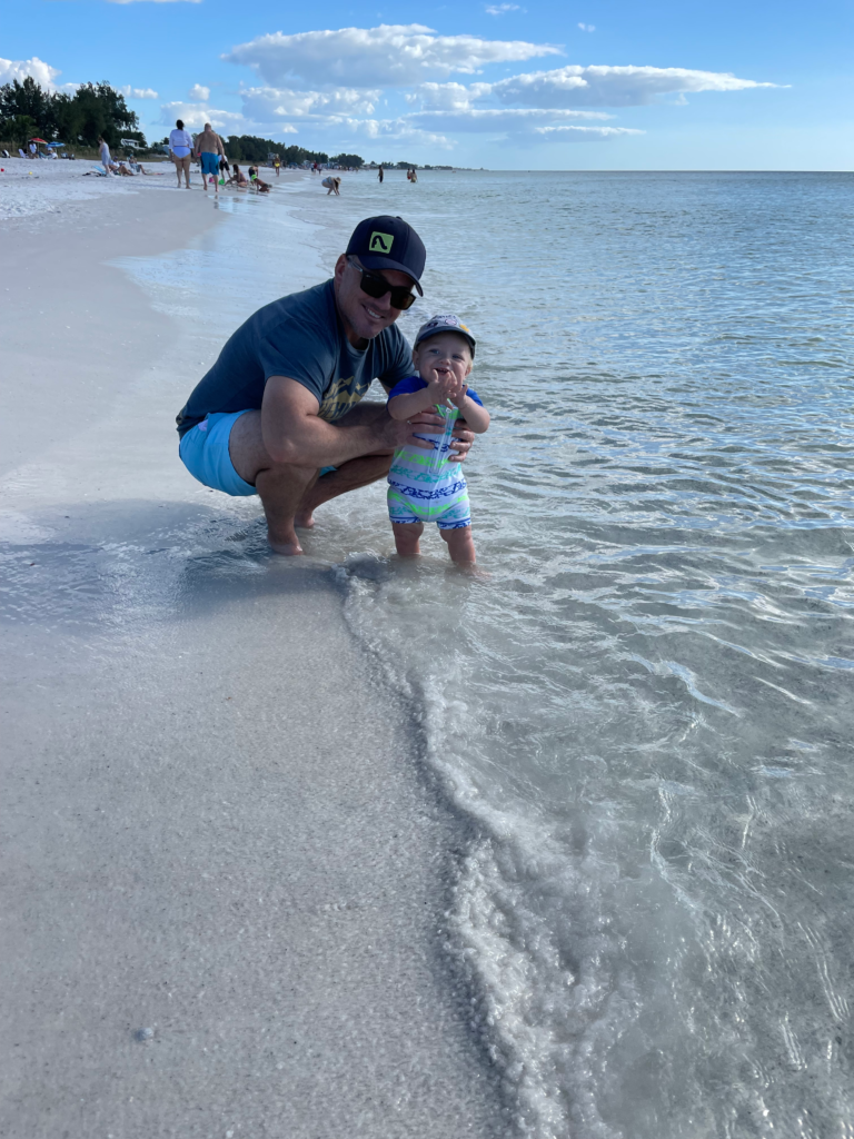 Kids playing in shallow water on Anna Maria Island family beach