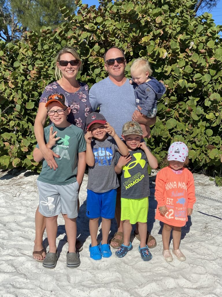 family on beach at anna maria island beach vacation