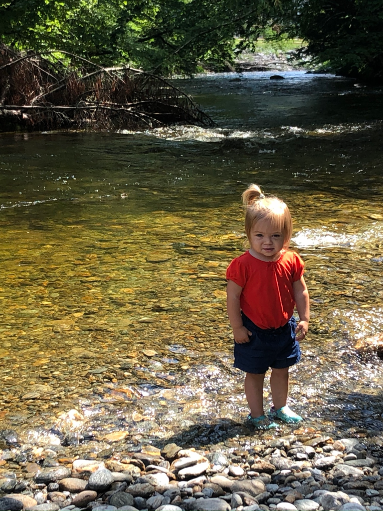 little girl in creek on Stowe Recreation Path in Stowe Vermont during summer