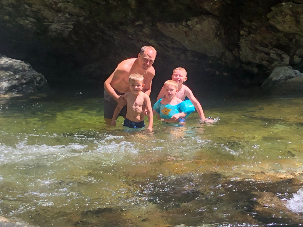 family at bingham falls in stowe vermont during summer