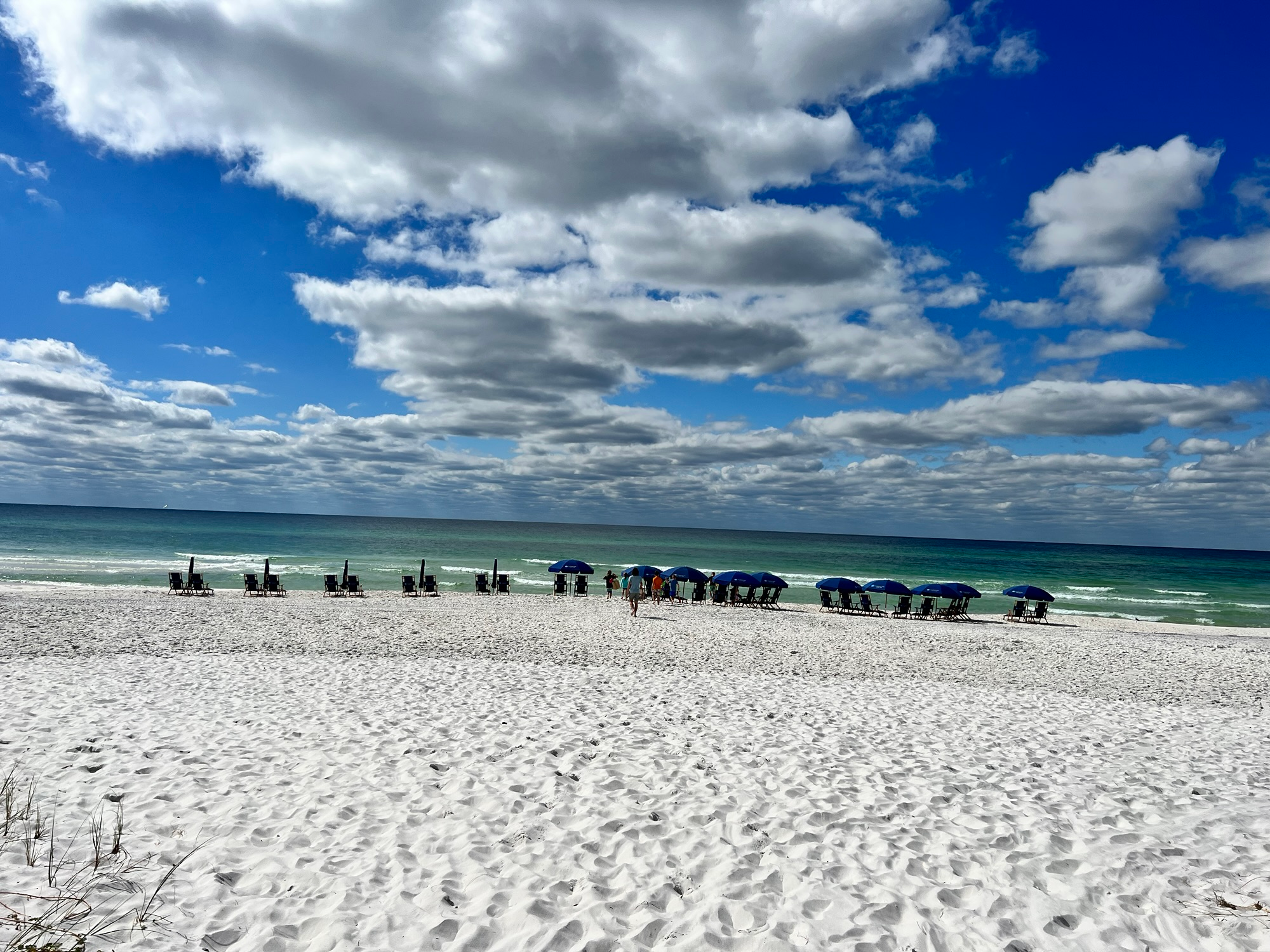 Sunny sandy beach with gentle waves, perfect for a family vacation
