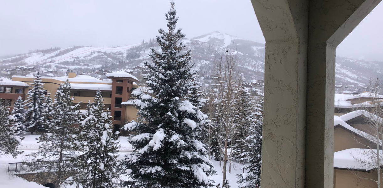 Snowy ski mountain view from a condo balcony, perfect for family ski trips with kids from Ohio