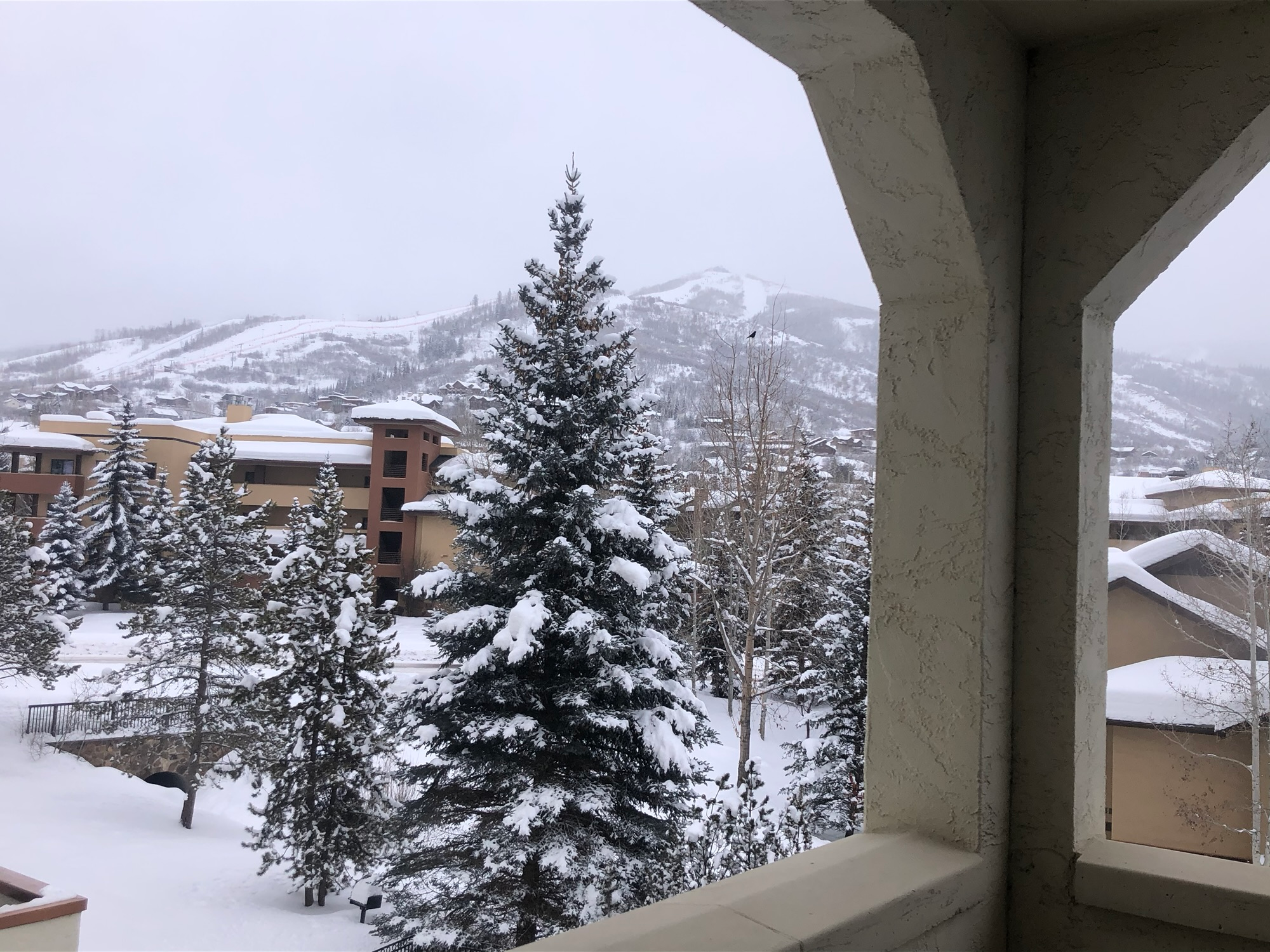 Snowy ski mountain view from a condo balcony, perfect for family ski trips with kids from Ohio