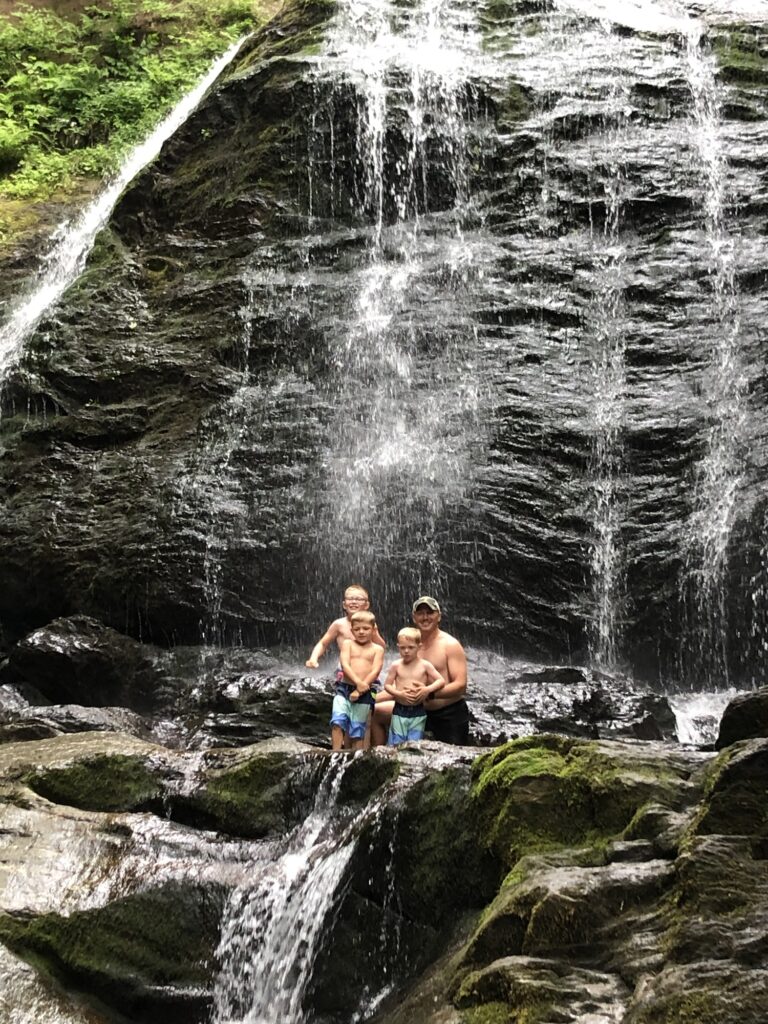 family at moss glenn falls in stowe vermont during summer