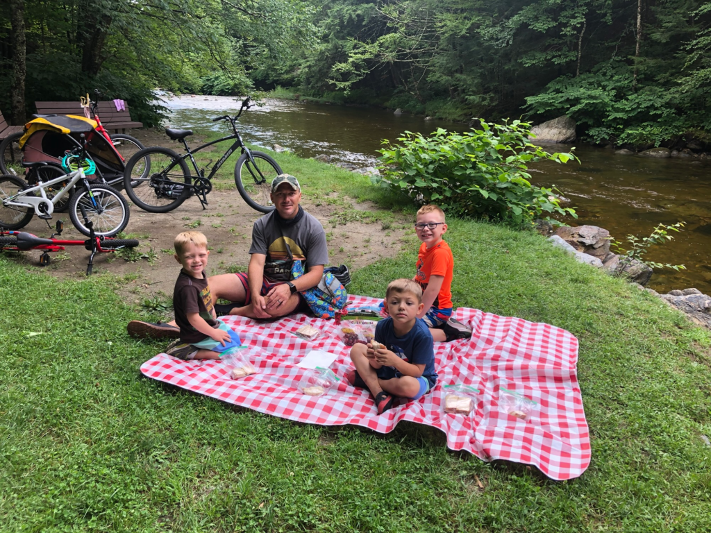 family picnicing on stowe recreation path in stowe vermont during summer