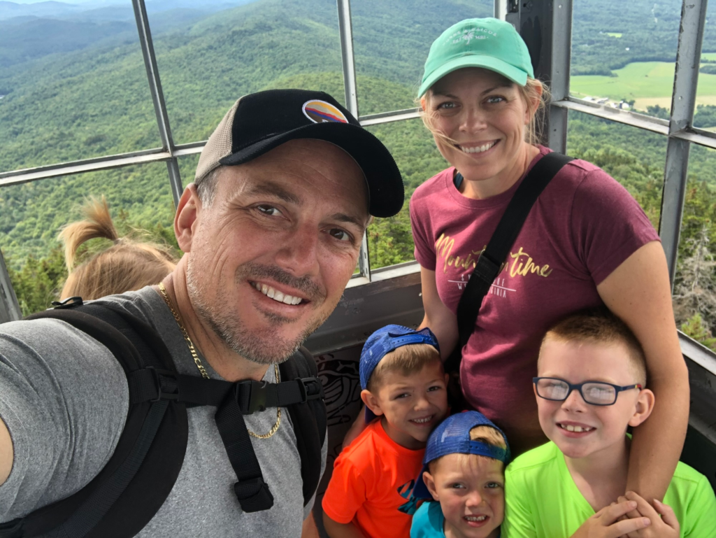family in firetower in stowe vermont during summer 