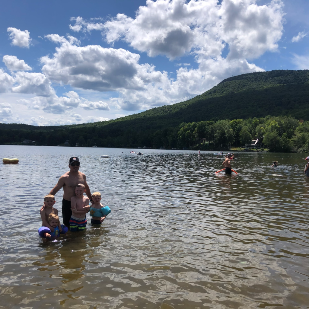 family in elmore lake in stowe vermont during summer