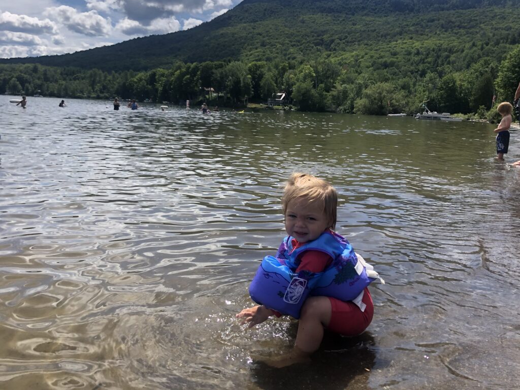 Girl in Elmore Lake in stowe vermont during summer