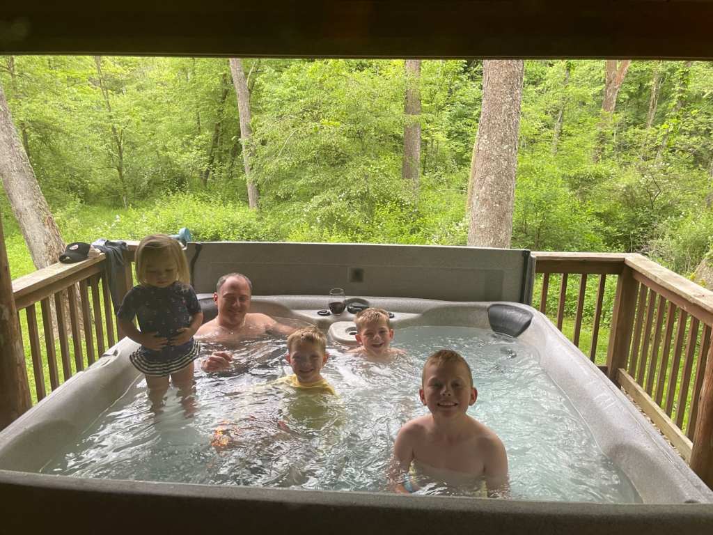 family in hot tub in hocking hills cabin