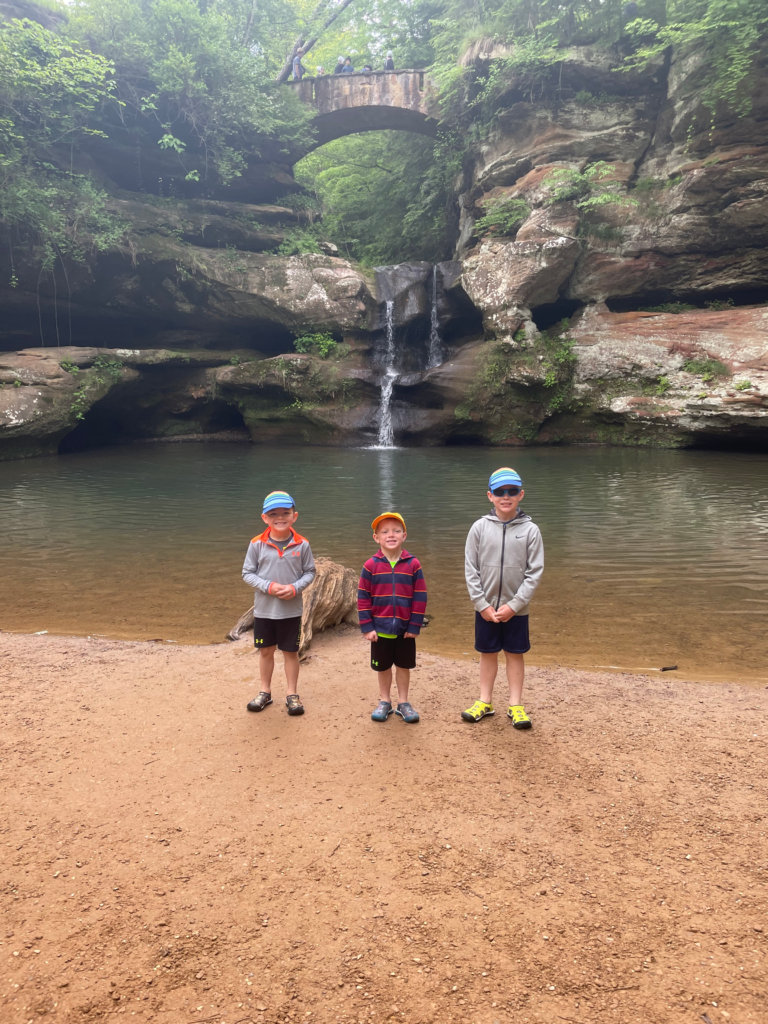 children in front of upper falls at old mans cave state park hocking hills ohio