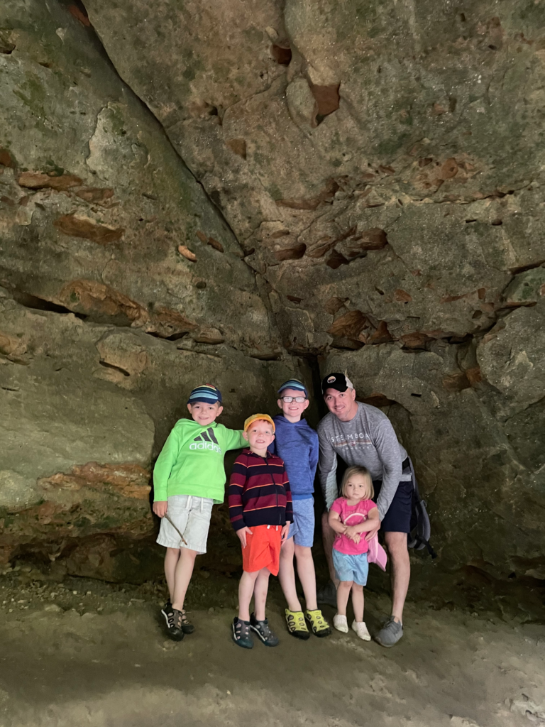 family next to rocks hocking hills wit kids