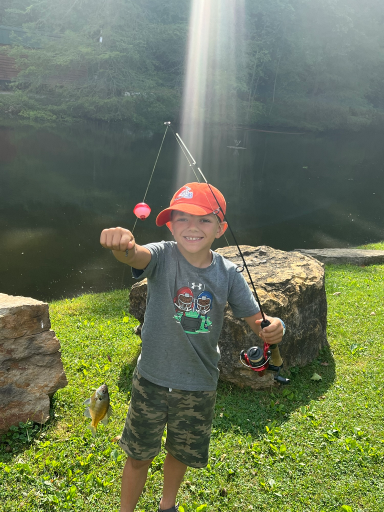boy with fishing pole and fish at Austin Lake Campground, Steubenville Ohio